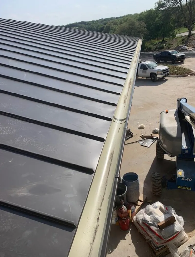 Standing seam panel and gutter detail on a metal roofing jobsite in Union Beach